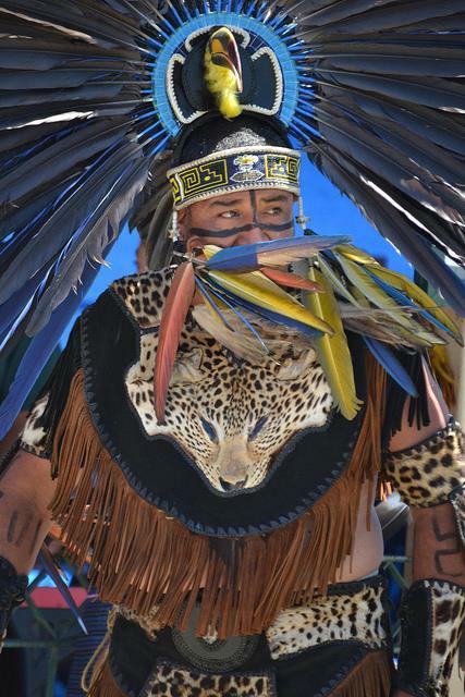 Aztec dancer in traditional regalia with feathered headdress